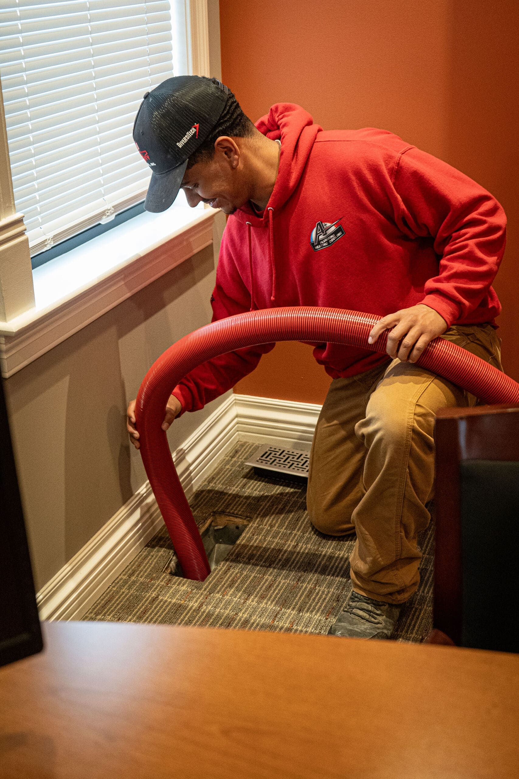 Technician cleaning air ducts