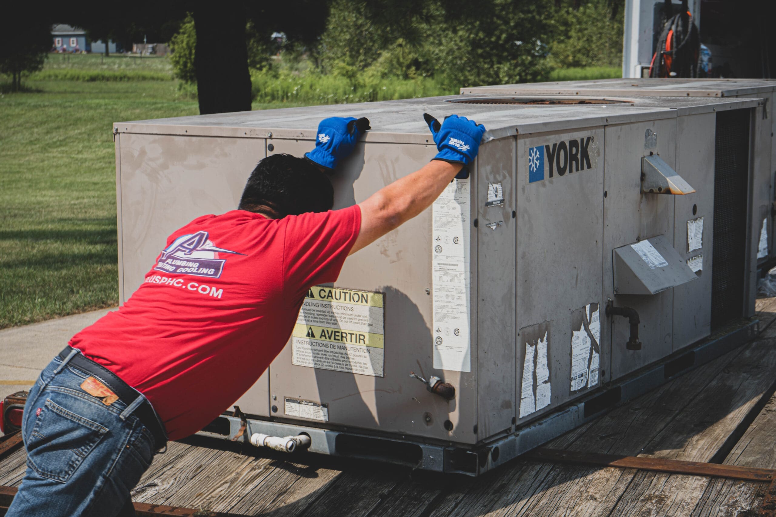 Technician moving York HVAC unit