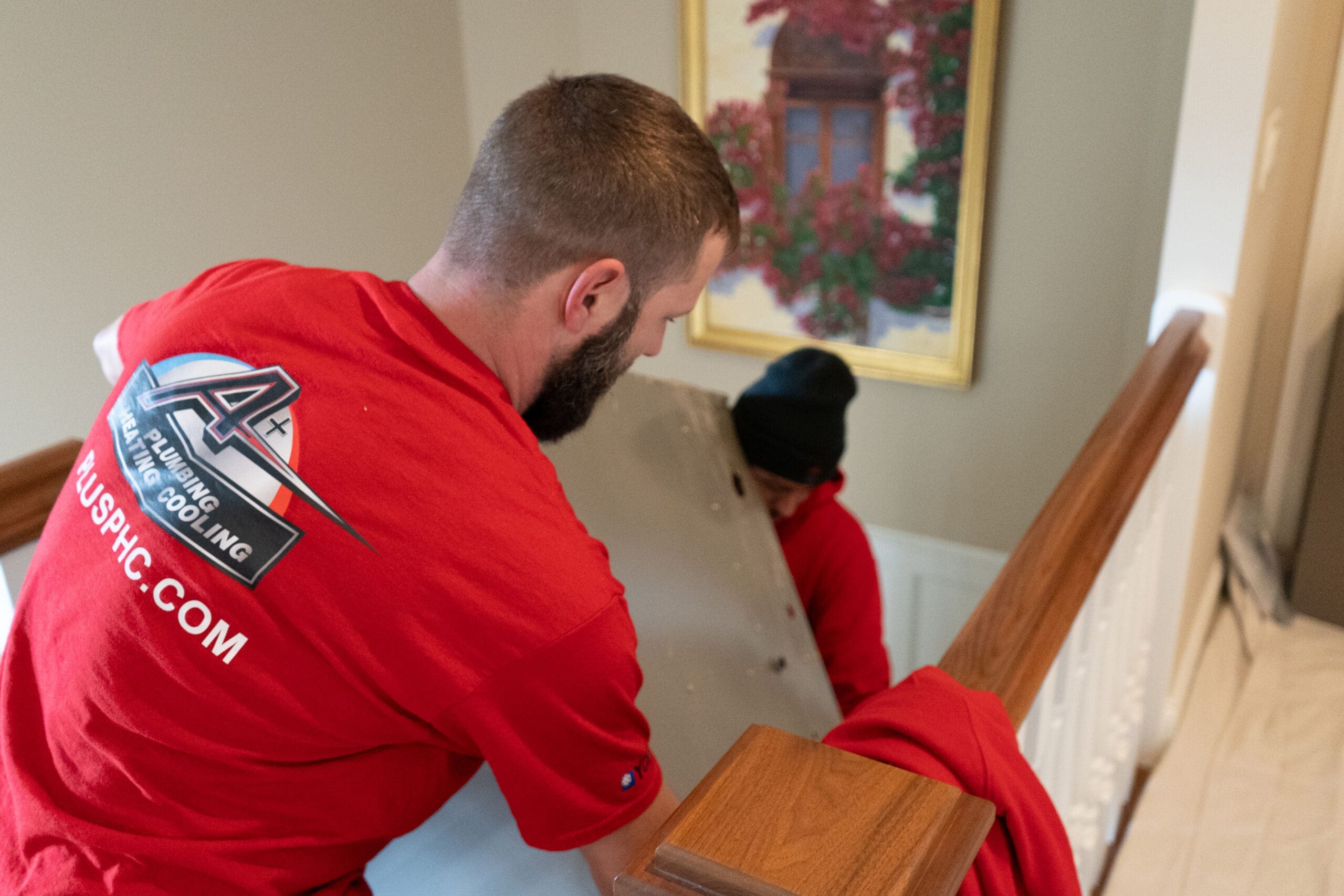 Technicians moving HVAC equipment